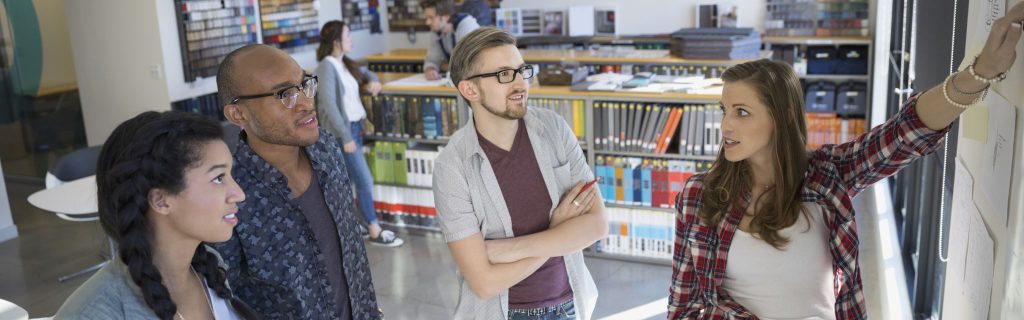 business people talking and looking at white board